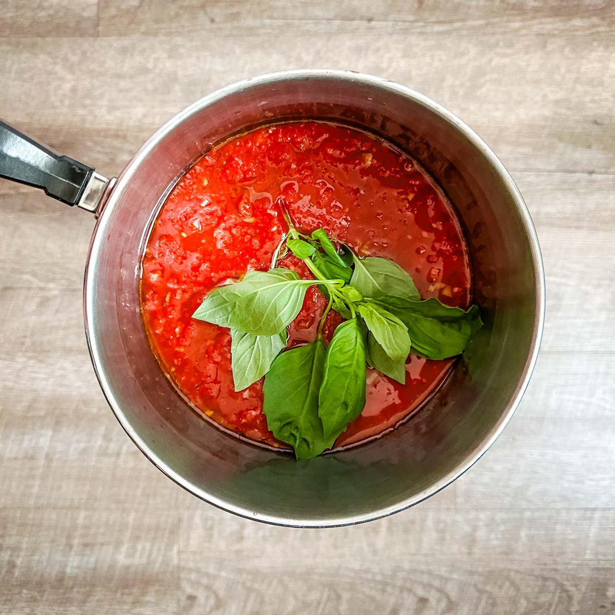 marinara sauce in a pot with basil