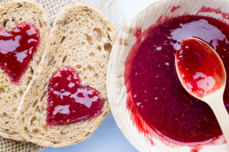 Jam heart-shaped cereal bread slices.