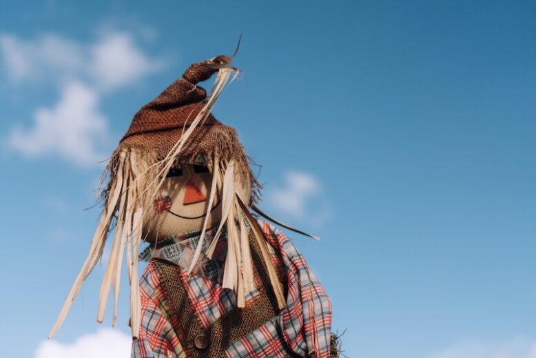 scarecrow against blue sky