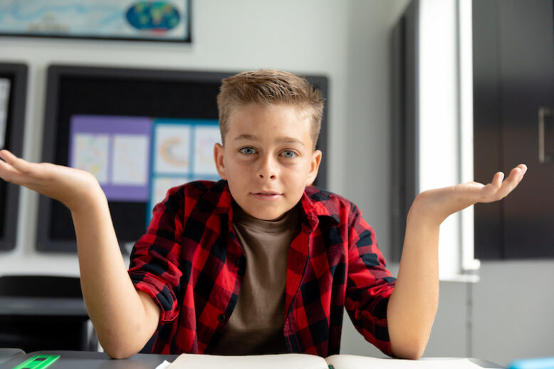 confused boy with arms up in the air