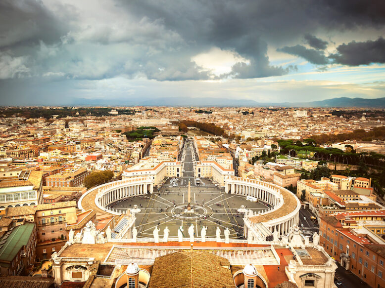 Famous Saint Peter's Square in Vatican and aerial view of the city, Rome, Italy.