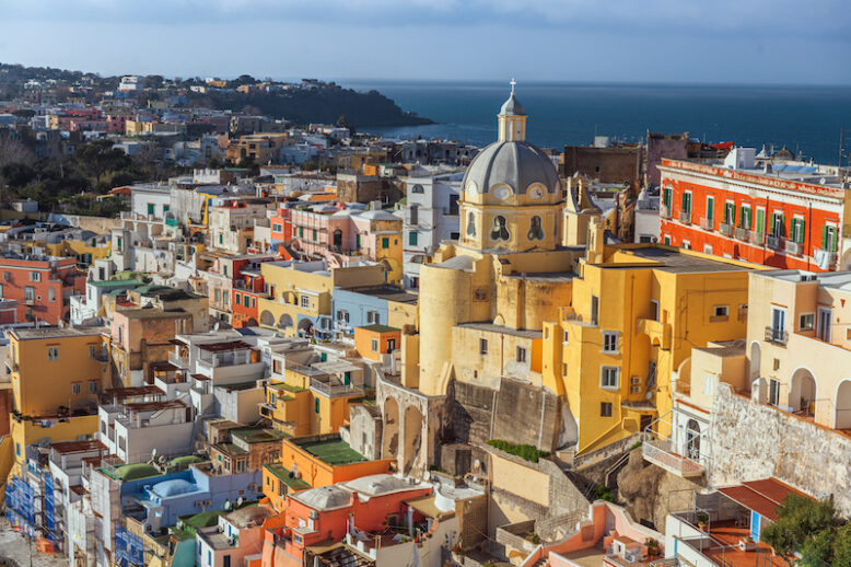 Procida, Italy old town skyline in the Mediterranean Sea during dusk.
