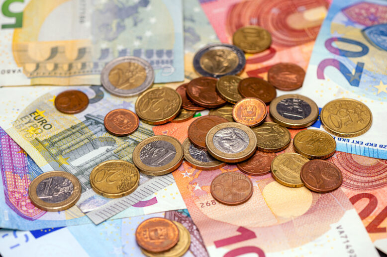 background of banknotes and euro coins of different denominations.