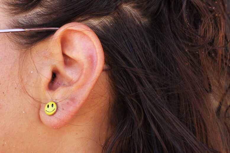 Ears with smiley face earrings