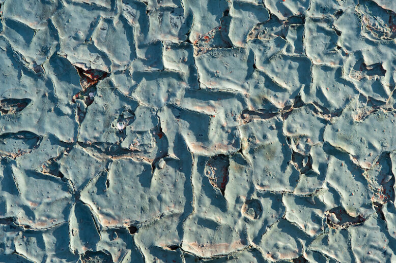 Closeup surface of old blue cracked paint.