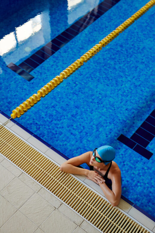 Female swimmer relaxing in the swimming pool