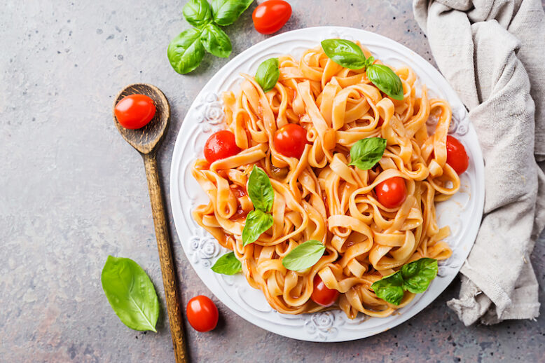 Pasta Fettuccine with tomato sauce and basil in a plate.