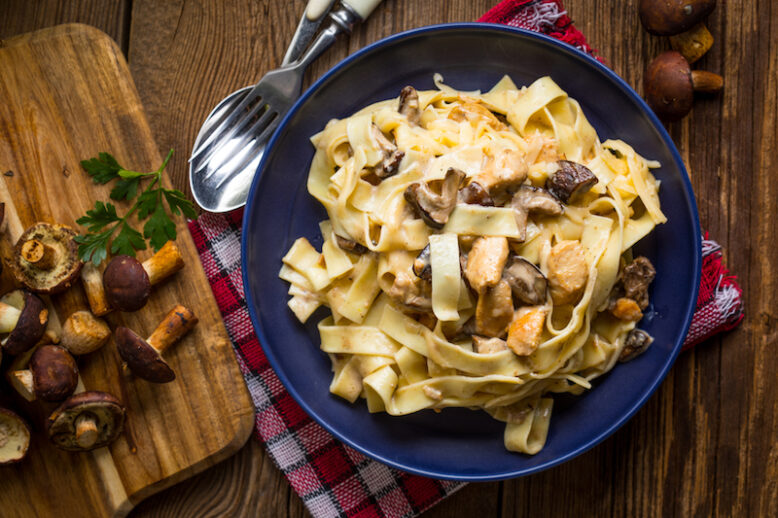 Tagliatelle pasta with forest mushrooms and chicken. Small depth of field.