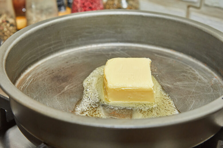 Butter is melted in frying pan over low heat.