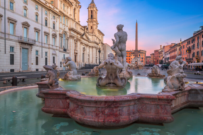 Fountains in Piazza Navona in Rome, Italy at twilight.