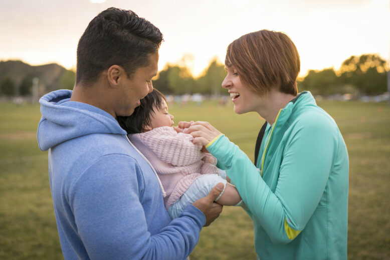 Couple playing with baby in park