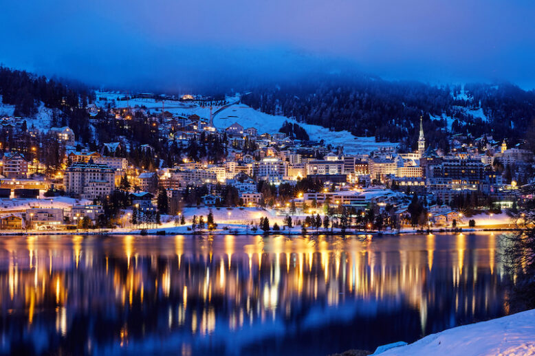 St. Moritz resort at night. Lights reflecting on lake. Switzerland