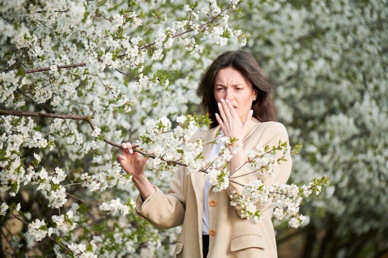 Woman allergic suffering from seasonal allergy at spring