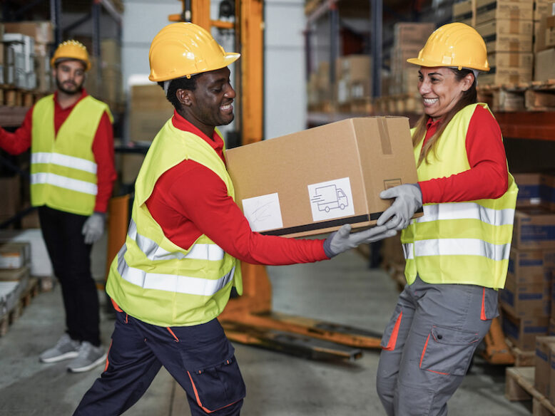 Staff working in warehouse with protective wear 