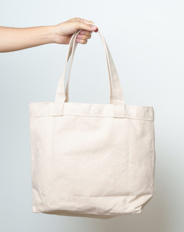 Woman hand holding Eco Shopping tote bag 