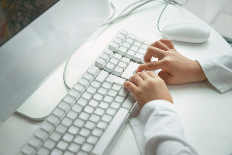 Child hands typing on computer keyboard