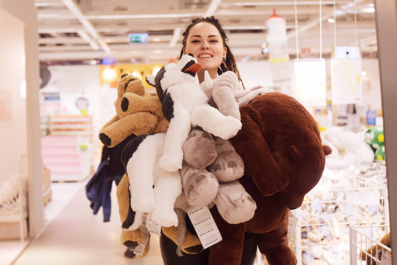 Lady holding lots of stuffed animals