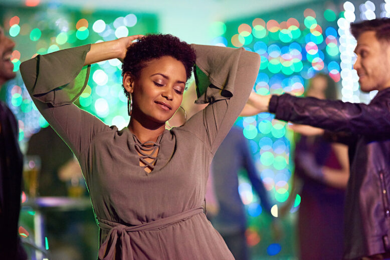 a beautiful young woman dancing in a nightclub