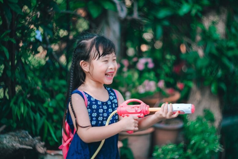 child playing with a water gun