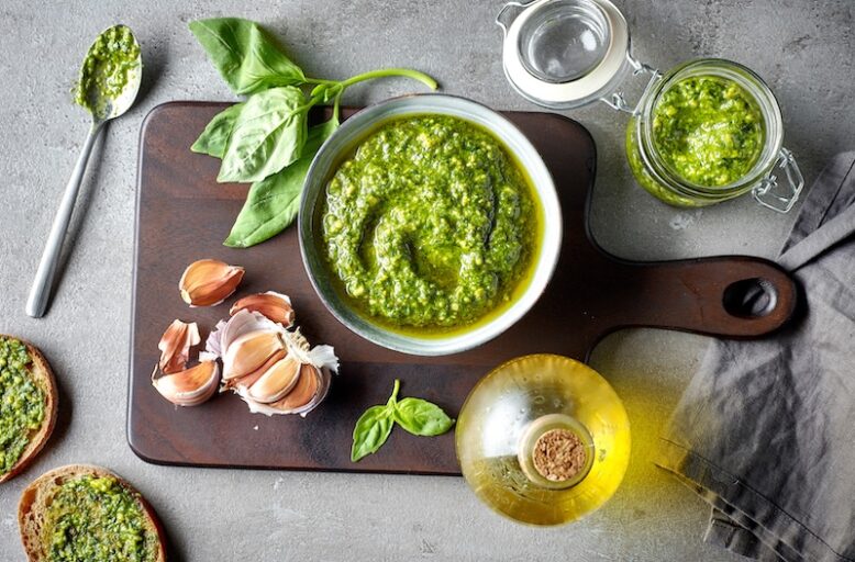 bowl of basil pesto on grey table