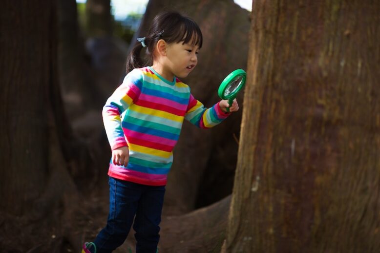 girl searching with magnifying glass