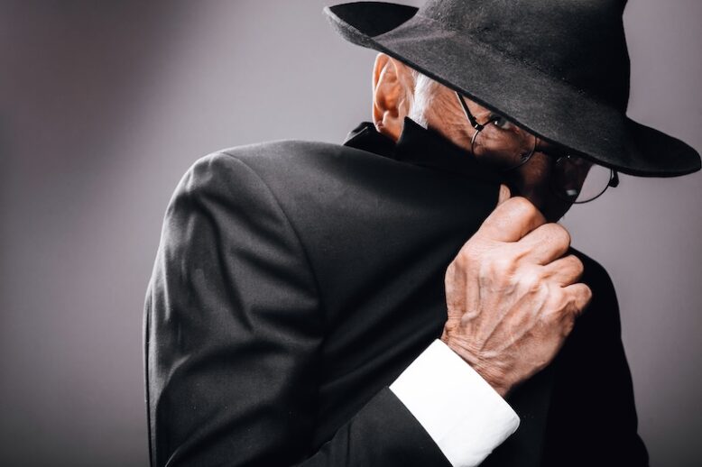 old male actor in suit and hat